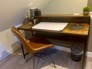 a wooden desk with a chair in front of it at Fantastic Location, Annexe with Hot Tub in Warmingham
