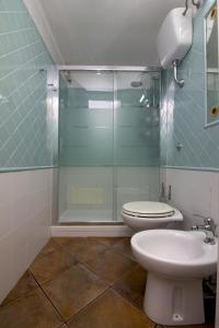a bathroom with a toilet and a glass shower at Almà in Torre delle Stelle