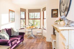 a living room with a couch and a table at Rosary Road Apartment in Norwich