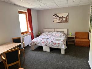 A bed or beds in a room at Penzión Michaela Vyhne