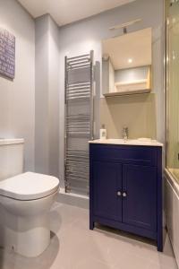 a bathroom with a toilet and a sink at Host & Stay - The Courtyard in Snettisham