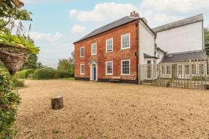 an old brick house with a large yard at Mill House in East Dereham