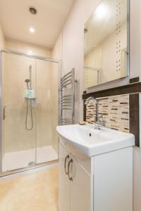 a bathroom with a sink and a shower at Woodside House in Costessey