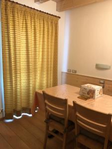 a room with a table with chairs and a box on it at Agritur Masi Brenta in Rovereto