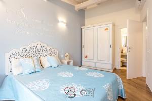a bedroom with a bed with a blue and white bedspread at Cuore di Sardegna in Valledoria