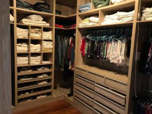 a walk in closet filled with lots of clothes at Casa Branca in Belo Horizonte