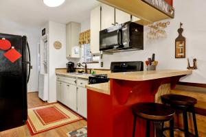 a kitchen with a red island in the middle at Mountain Getaway by Big Bear Vacations Adorable Sugarloaf Retreat in Sugarloaf +13 photos