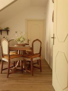 uma sala de jantar com uma mesa e duas cadeiras em DA LAURA em Bottidda