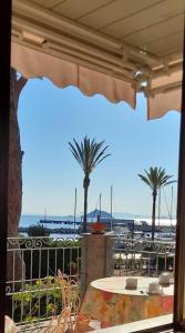 a view of the ocean from a patio with palm trees at Hotel Maristella in Cavo