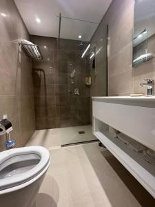 y baño con aseo, lavabo y ducha. en Hawana Salalah luxury 1BR TH with private pool, en Ma‘mūrah