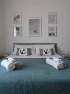 a bedroom with a large bed with towels on it at B&B Stella Di Mare - Ortona in Ortona