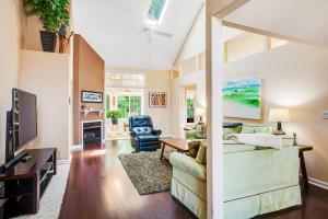 a living room with a couch and a tv at Plantations East - 221 Lakeside Dr in Lewes
