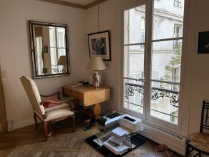 a living room with a desk and a window at 100m2 flat appartement d'artiste in Paris