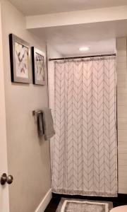 a bathroom with a shower with a shower curtain at Cozy Getaway near SLC Airport & Downtown - 1st floor Apartment in Salt Lake City