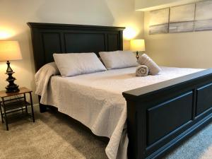 a bedroom with a large bed with a black headboard at Cozy Getaway near SLC Airport & Downtown - 1st floor Apartment in Salt Lake City