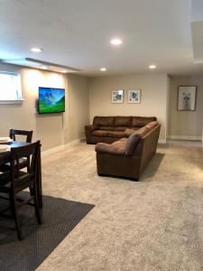 a living room with a couch and a table at Cozy Getaway near SLC Airport & Downtown - 1st floor Apartment in Salt Lake City
