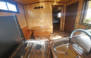 a kitchen with a sink and a stove at Cabañas Christophe in Hanga Roa