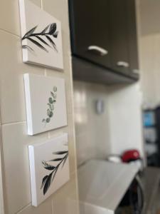 a kitchen with some cards on the wall at Wabisabi Residence in Araxá