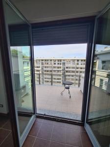 a balcony with a table and a view of a building at Milano Santa Giulia Business Apartment - Olimpiadi 26 in Milan