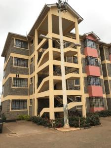 a large apartment building with a pole in front of it at Maliaways Comfy Airbnb-Jkia in Nairobi