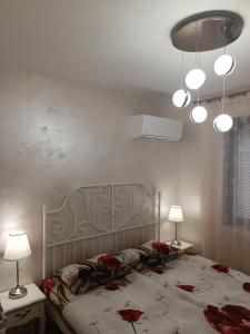 a bedroom with a bed with red roses on it at Апартамент 3 А in Varna City