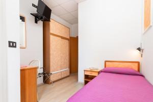 A bed or beds in a room at Albergo Eva