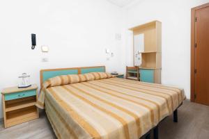 A bed or beds in a room at Albergo Eva