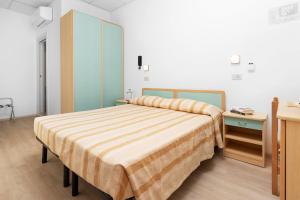 A bed or beds in a room at Albergo Eva