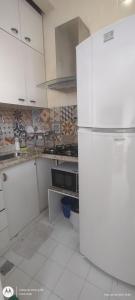 a kitchen with a white refrigerator in a room at Temporada Copacabana Salu in Rio de Janeiro