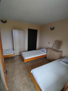 a room with two beds in a room at Prostor Guest House in Byala