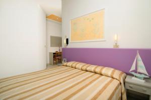 A bed or beds in a room at Albergo Eva