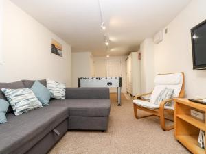 a living room with a couch and a chair at Pilchard Cottage in Penzance