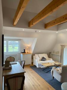 a living room with a bed and a table at HofGut Bockelkathen Apartment 3 in Lüdersburg