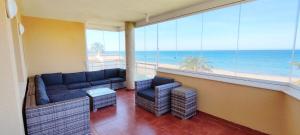 a living room with a couch and a view of the ocean at Apartamento Catamarán II by DENIA COSTA in Denia