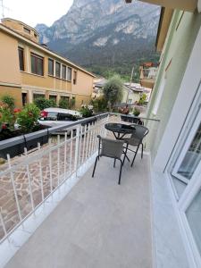 einen Balkon mit einem Tisch, Stühlen und einem Berg in der Unterkunft Bellariva in Riva del Garda