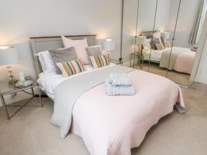 a bedroom with a large bed with two towels on it at Robin Hill in St Austell