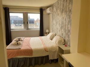 a small bedroom with a bed and a window at Liber Guest House in Braga