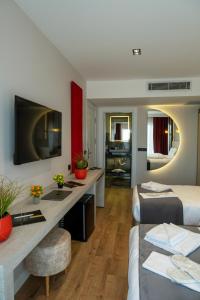 a hotel room with a bed and a desk with a sink at Linda Port Hotel in Istanbul