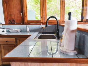 a kitchen counter with a sink and aaucet at Casa Laguna: Best View In The World in Santa Cruz La Laguna
