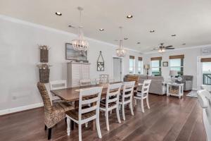 a dining room and living room with a table and chairs at Almost Heaven in Dauphin Island