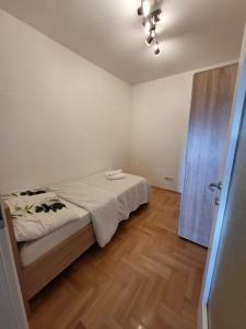 a bedroom with a bed and a wooden floor at Luxury Central Apartment in Strumica