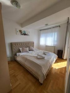 a bedroom with a large bed with two pillows on it at Luxury Central Apartment in Strumica
