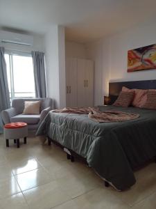 a bedroom with a large bed and a couch at Centro Apart Home in Jesús María