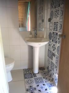a bathroom with a sink and a toilet at Casa Río Calle Calle in Valdivia