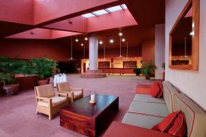 a lobby with a couch and a table and chairs at Las Brisas Huatulco in Santa Cruz Huatulco