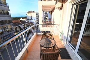 a balcony with a table and chairs on a balcony at THE WHOLE PACKET Β3 center with parking in Larisa