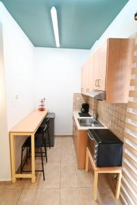 a small kitchen with a sink and a table at THE WHOLE PACKET Β3 center with parking in Larisa