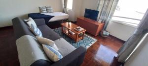 a living room with a couch and a bed at Costa Azul in Porto Moniz