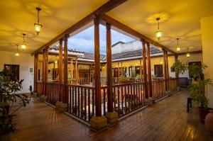 a lobby of a building with columns and lights at ViaVia Cafe Ayacucho in Ayacucho