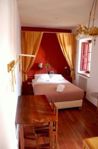 a bedroom with a large bed and a table at ViaVia Cafe Ayacucho in Ayacucho
